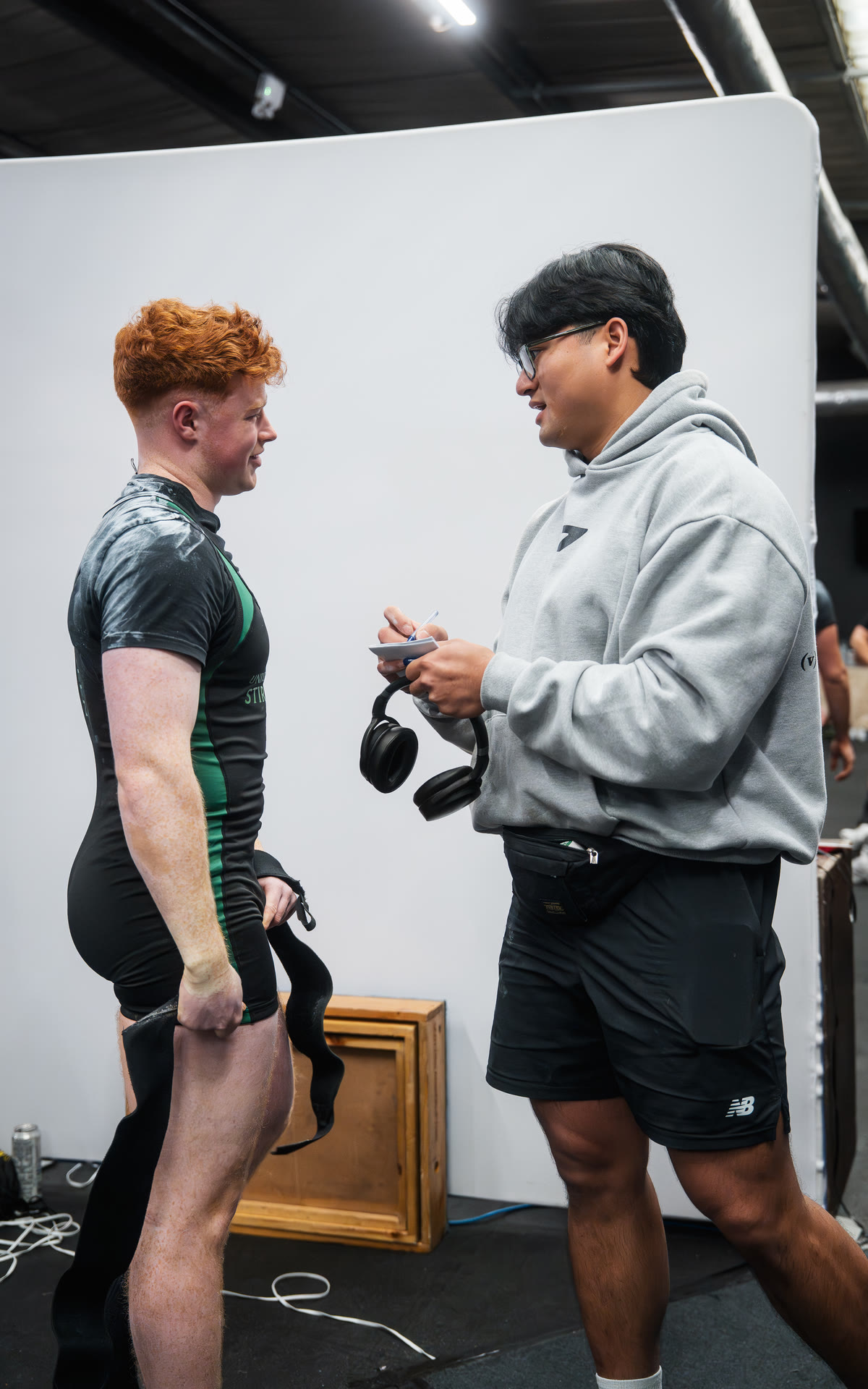 Apto Performance coach with a lifter after a medal-winning performance